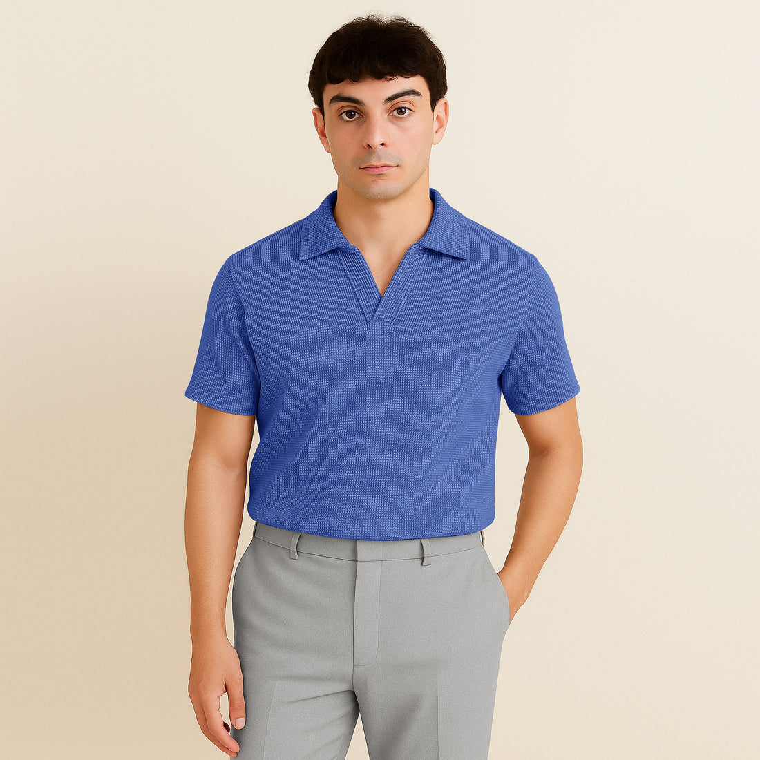Man wearing a textured azure blue short sleeve polo shirt and light grey pants