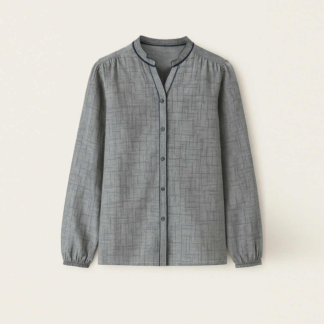 Woman wearing grey matching shirt and trousers set with geometric pattern, stylish casual wear.