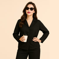 Woman in black button-up suit with sunglasses holding coffee cup, modern fashion