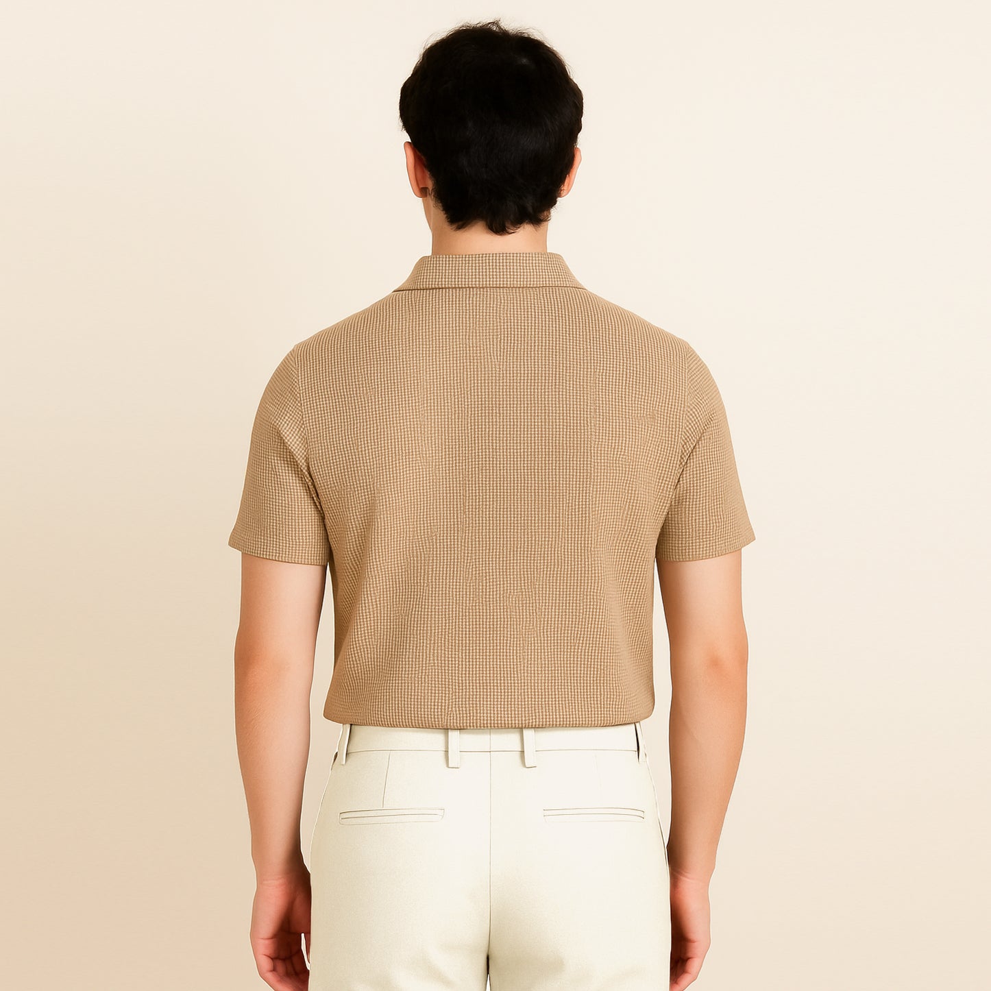 Back view of man in beige textured short sleeve polo shirt and cream pants