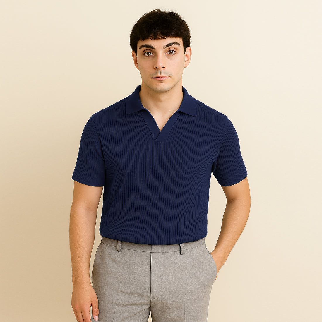 Man wearing a navy blue ribbed short sleeve polo shirt and beige trousers