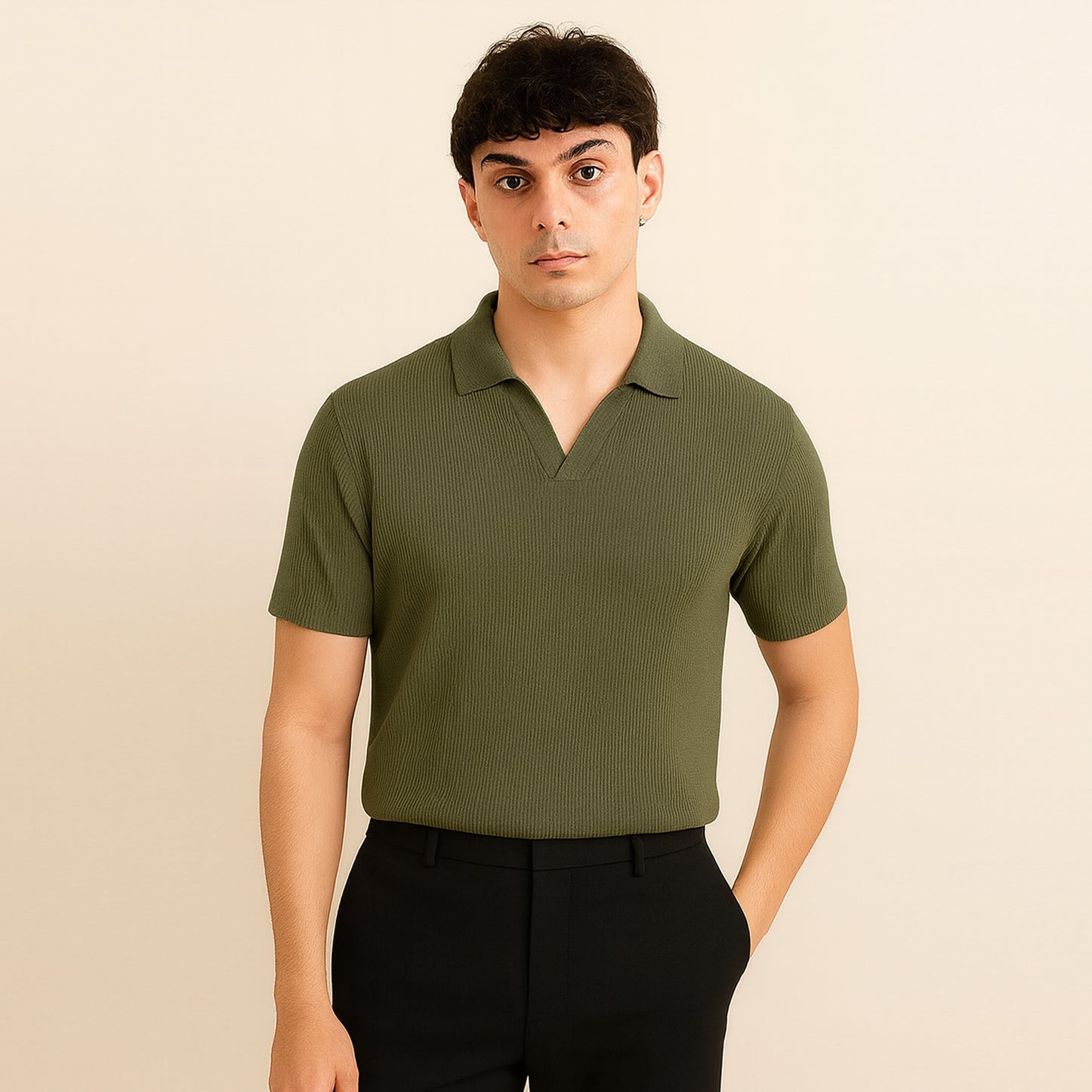 Man wearing olive green short sleeve polo shirt and black pants, neutral background