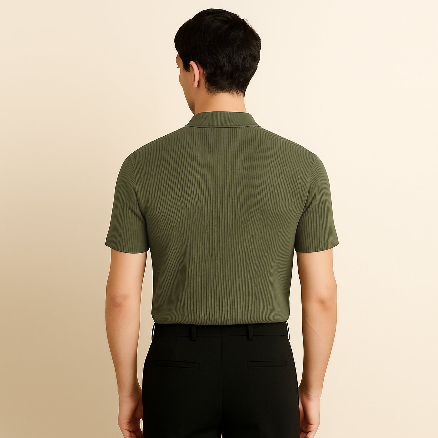 Back view of man wearing olive green ribbed polo shirt and black pants