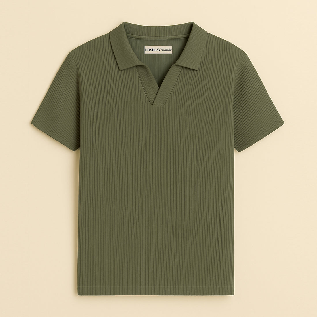 Man wearing olive green short sleeve polo shirt and black pants, neutral background