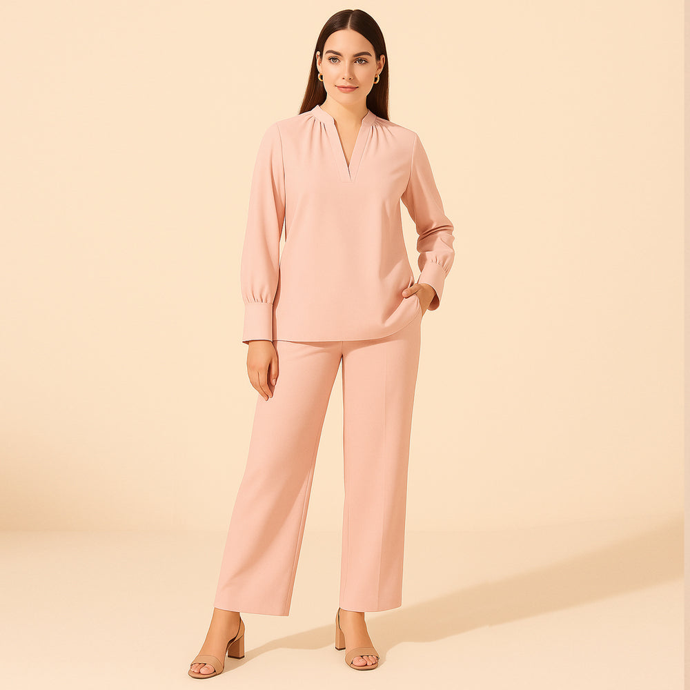 Woman wearing light pink long sleeve top and matching straight pants, modern stylish outfit
