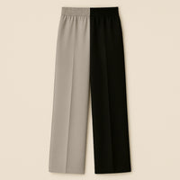 Two-tone straight leg trousers with elastic waistband, half beige and half black, laid flat