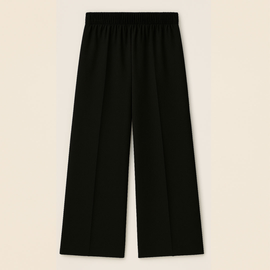 Black wide-leg trousers with elastic waistband, flat front, and straight hem on beige background.