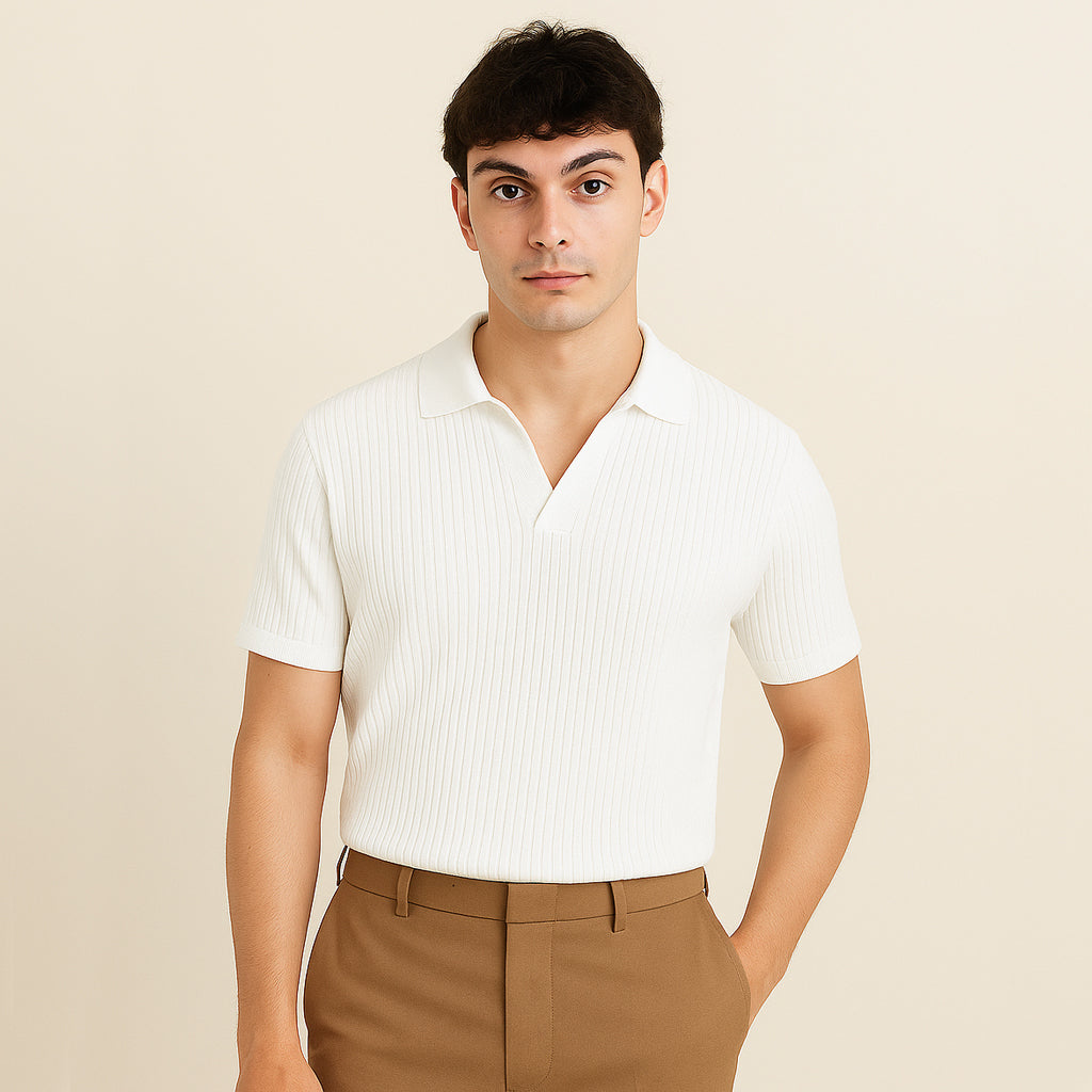 Man wearing a white ribbed short sleeve polo shirt with brown trousers, neutral background