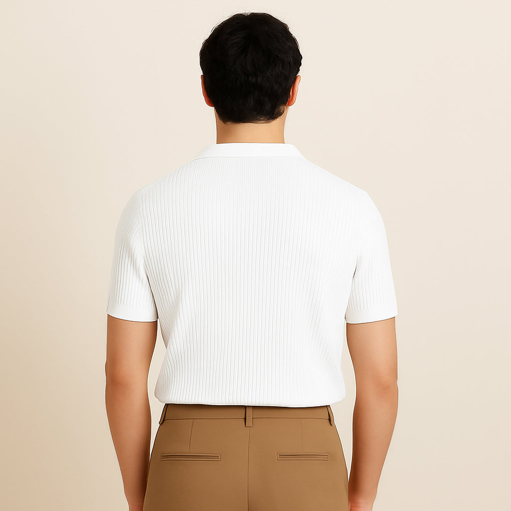 Man wearing a white ribbed short sleeve polo shirt and tan pants, back view