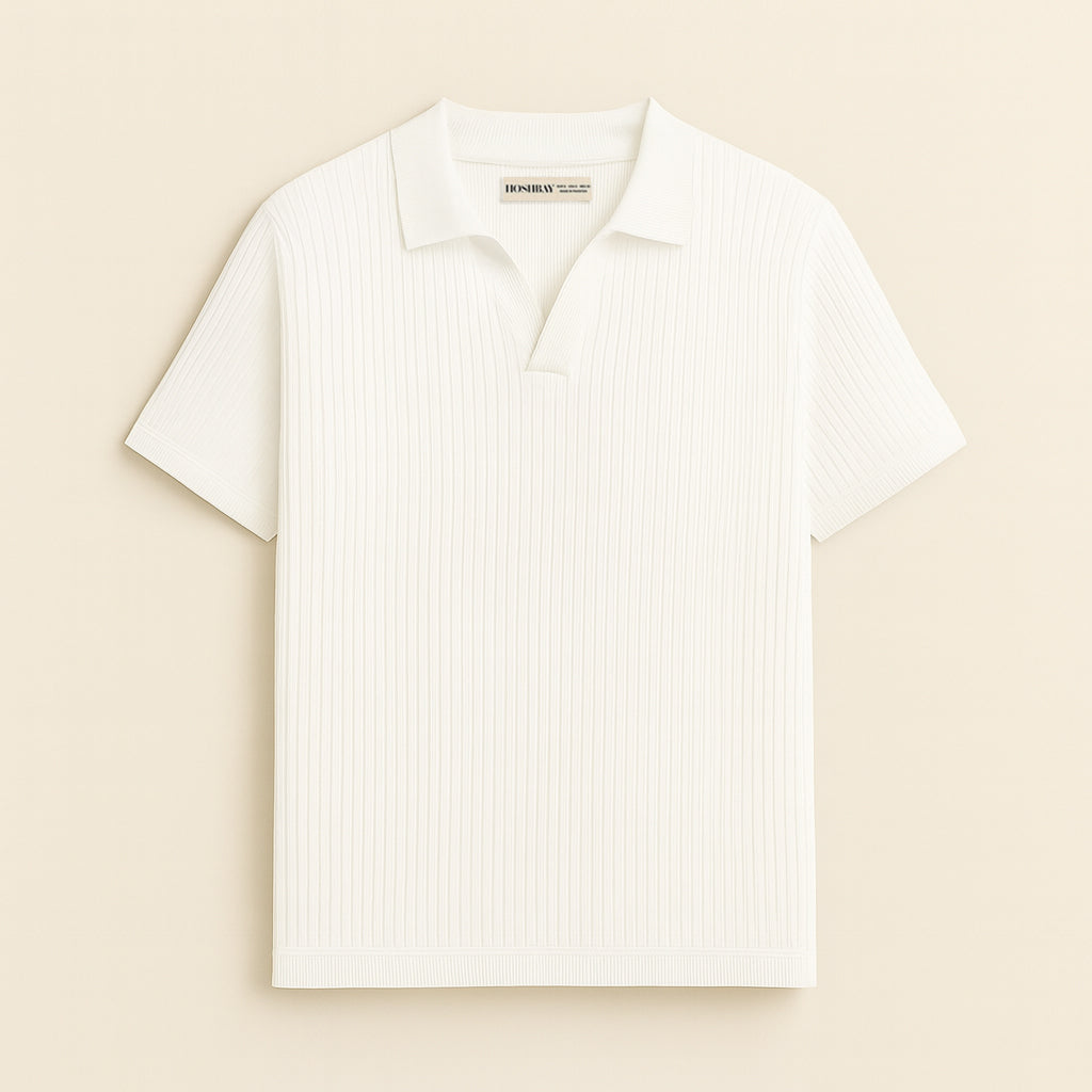 Man wearing a white ribbed short sleeve polo shirt with brown trousers, neutral background